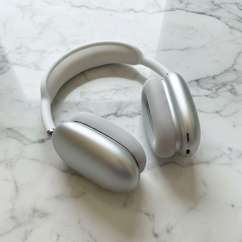 After: silver AirPods Max headphones on a marble counter