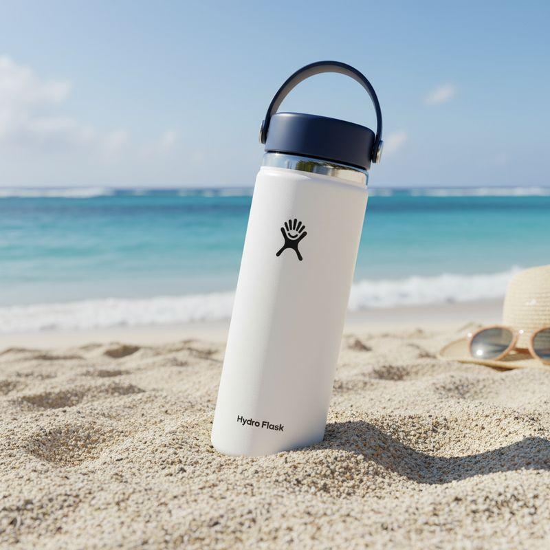 After: the Hydro Flask bottle standing in sand on a sunny beach